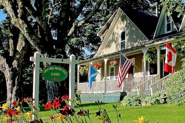 West Hill House B&B exterior with front porch and gardens
